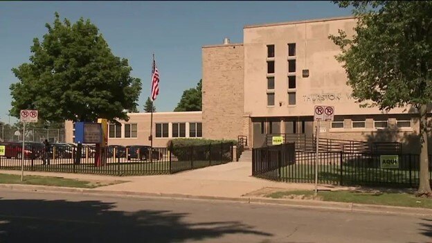 This picture shows the front of a middle school taken from across a street.
