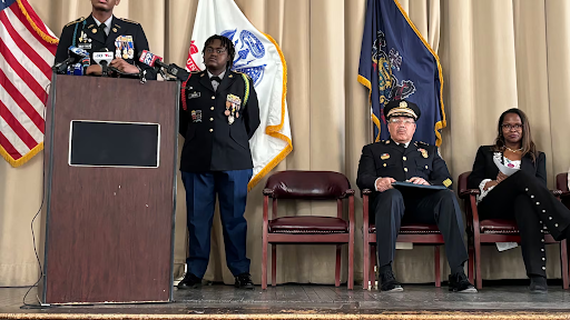 Philly press conference two men in uniform standing one man and woman in uniform sitting