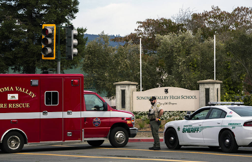 Sonoma Valley High School sign with a fire truck and police car in front.