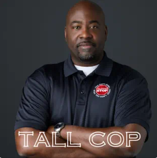 Tall Cop image of black man with arms crossed