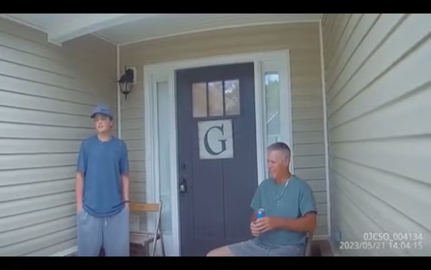 This is a photo of Colt Gray standing and his father sitting outside of their home.