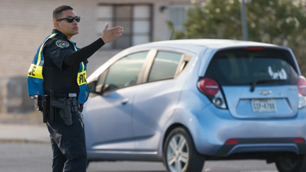 Police officer in road directing traffic.