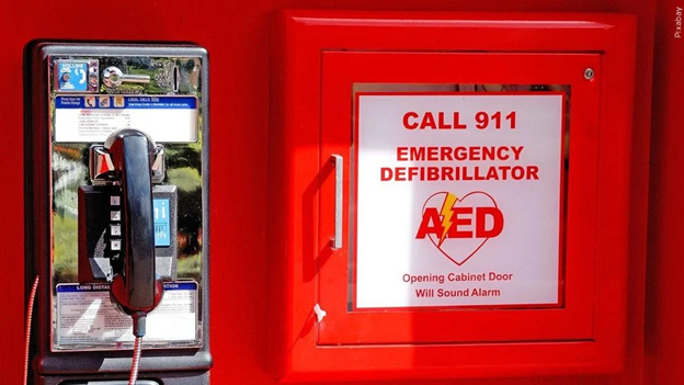 call 911. Image of a phone and AED device