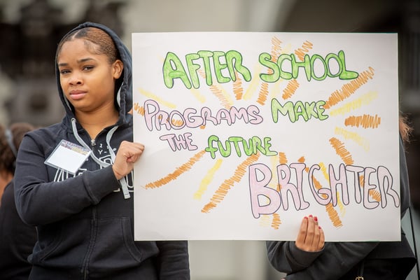 Student holding sign at 2023 Afterschool Advocacy Day Rally, 