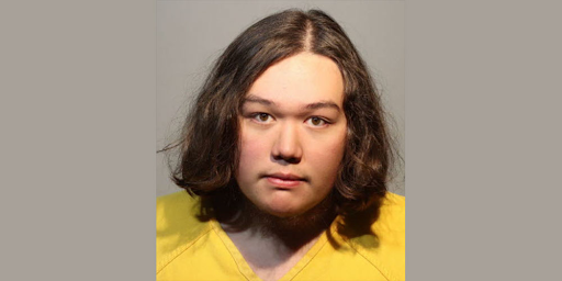 teenager with shoulder length hair in yellow shirt